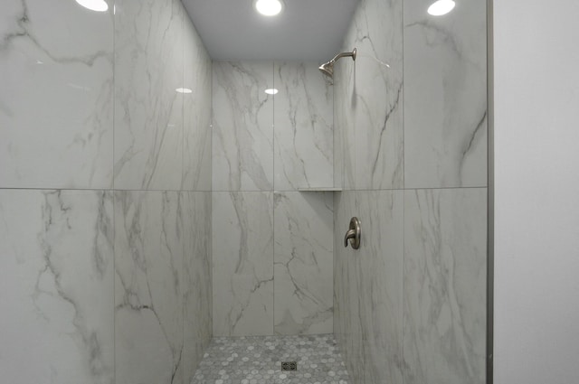 full bathroom featuring a marble finish shower