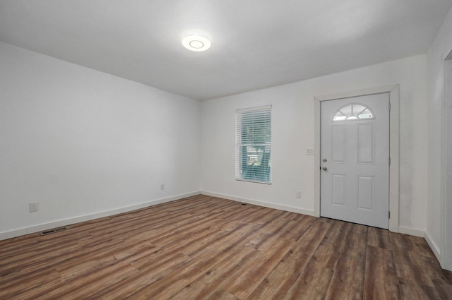 entrance foyer with visible vents, baseboards, and wood finished floors