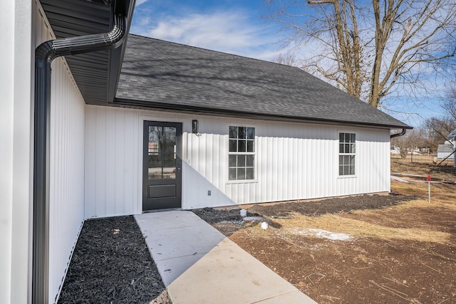 property entrance with roof with shingles