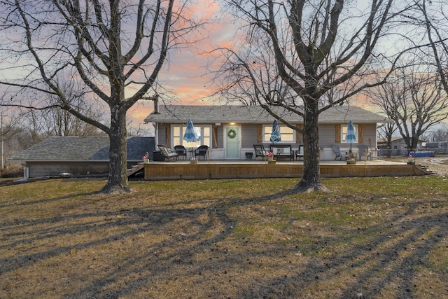 view of front facade featuring a deck and a front lawn