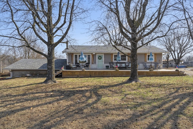 ranch-style home with a deck and a front lawn