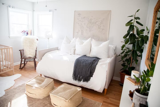 bedroom with baseboards and wood finished floors