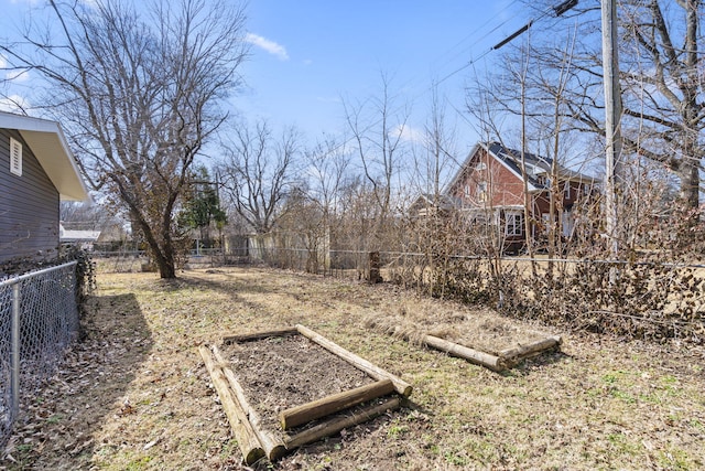 view of yard with a fenced backyard and a vegetable garden