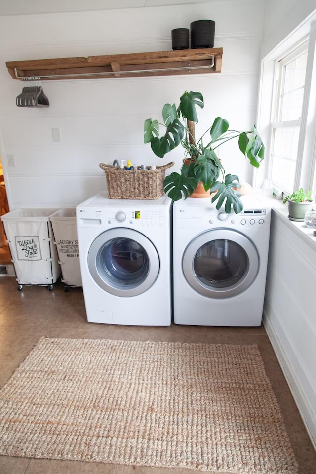 clothes washing area featuring laundry area and separate washer and dryer