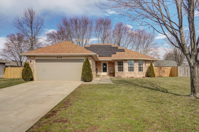 ranch-style house with an attached garage, fence, solar panels, and brick siding