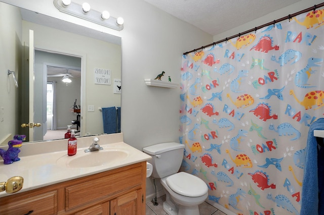 full bathroom featuring a textured ceiling, vanity, toilet, and tile patterned floors