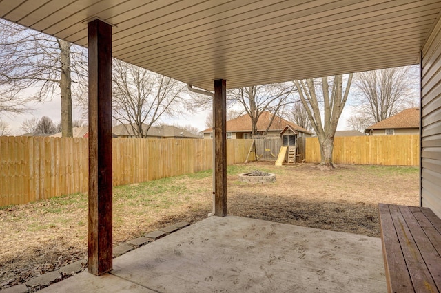 view of yard with a patio area, a fenced backyard, and a playground