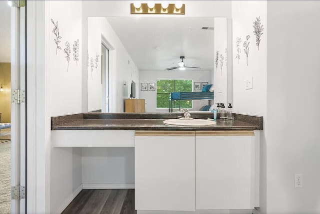 bathroom featuring ceiling fan, wood finished floors, and vanity