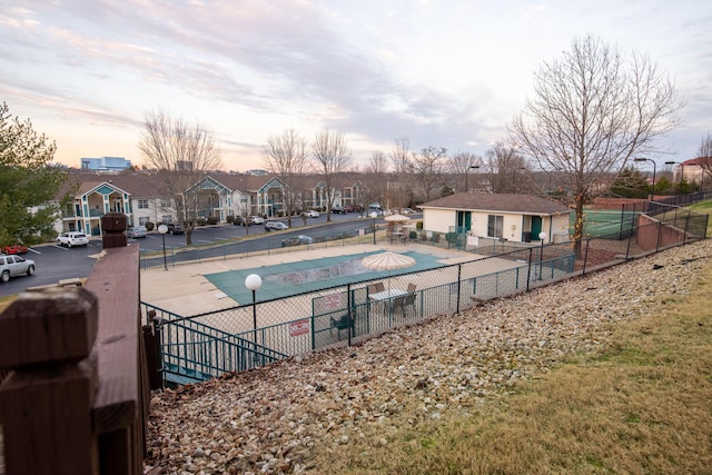 view of swimming pool featuring a residential view and fence