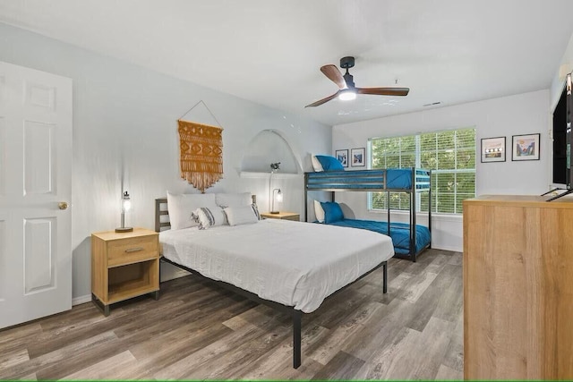 bedroom featuring baseboards and wood finished floors