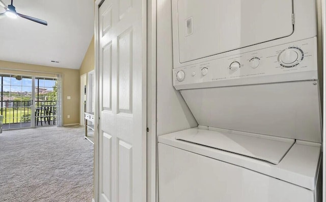 laundry room featuring laundry area, baseboards, visible vents, stacked washer and clothes dryer, and carpet flooring