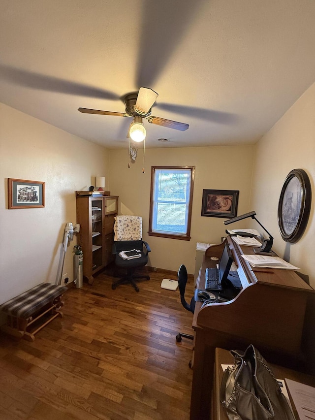 interior space featuring dark wood-type flooring and ceiling fan