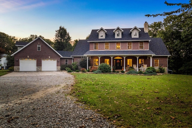 view of front of home featuring a garage, concrete driveway, a front yard, a porch, and brick siding