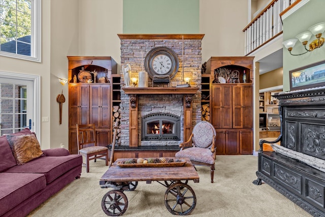 carpeted living room featuring a fireplace and a high ceiling