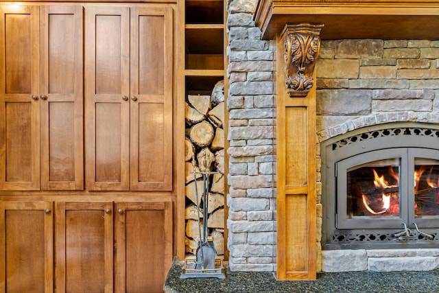 interior details featuring a warm lit fireplace