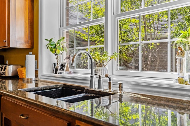 details featuring dark stone counters and a sink