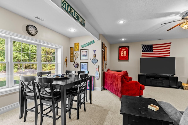 carpeted dining area with a ceiling fan, recessed lighting, visible vents, and baseboards