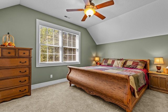 carpeted bedroom featuring vaulted ceiling, ceiling fan, visible vents, and baseboards