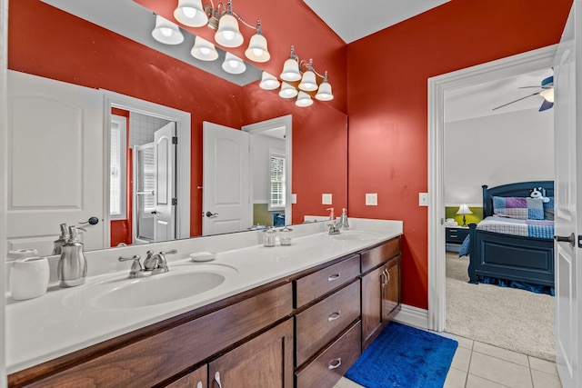 ensuite bathroom featuring double vanity, ceiling fan, tile patterned floors, ensuite bathroom, and a sink