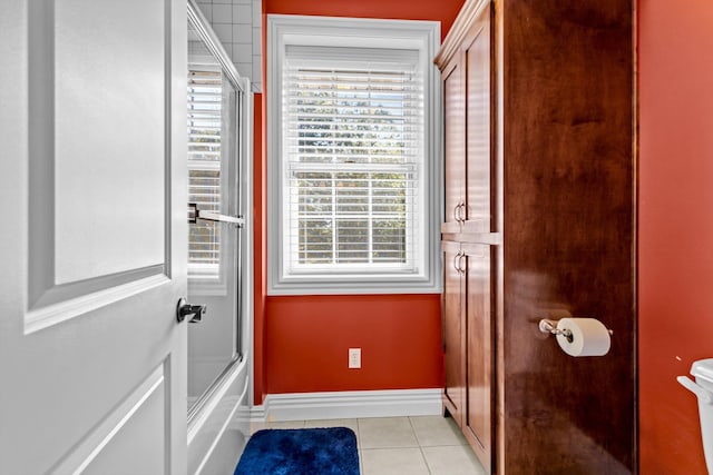 doorway to outside with light tile patterned floors and baseboards