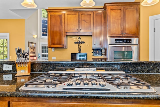 kitchen featuring appliances with stainless steel finishes and brown cabinets