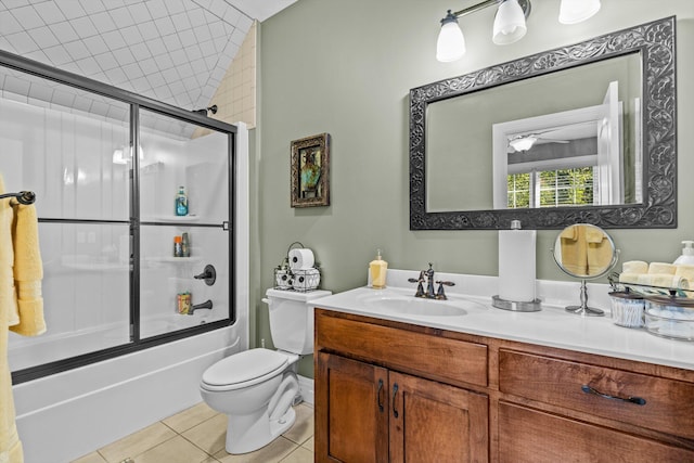 full bathroom featuring toilet, combined bath / shower with glass door, vanity, and tile patterned floors