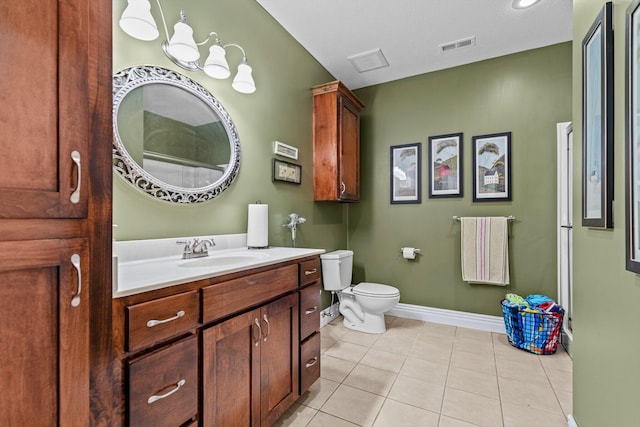 bathroom with visible vents, toilet, vanity, tile patterned flooring, and baseboards