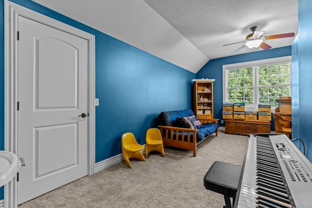 bedroom featuring a textured ceiling, ceiling fan, lofted ceiling, baseboards, and carpet