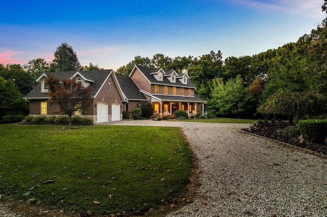 view of front of property with a garage, driveway, and a front yard