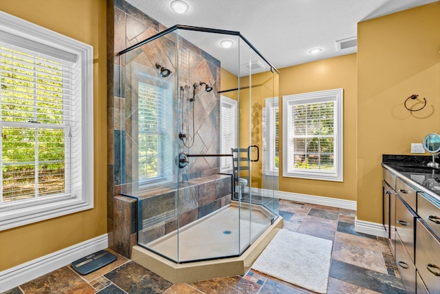 full bath with a healthy amount of sunlight, baseboards, and stone tile floors