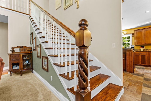 stairway featuring stone finish flooring, carpet floors, recessed lighting, and baseboards