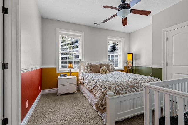 bedroom with visible vents, ceiling fan, light carpet, and baseboards