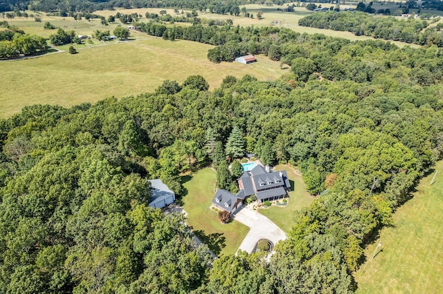 birds eye view of property featuring a rural view and a view of trees