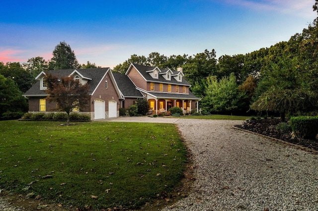 view of front of home featuring driveway and a lawn