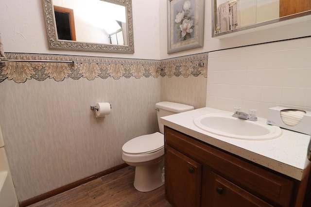 bathroom with a wainscoted wall, vanity, wood finished floors, and toilet