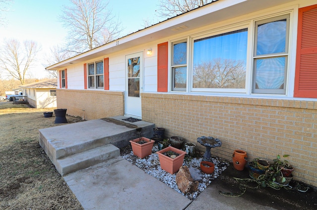 property entrance with brick siding