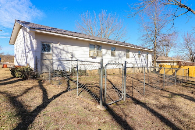 exterior space featuring a fenced front yard, a gate, and metal roof