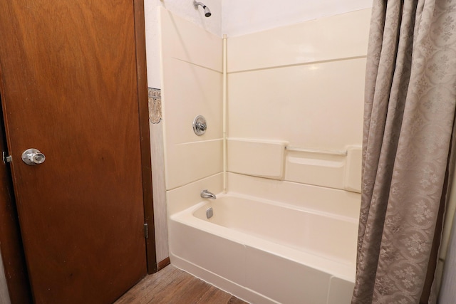 bathroom with shower / tub combo with curtain and wood finished floors