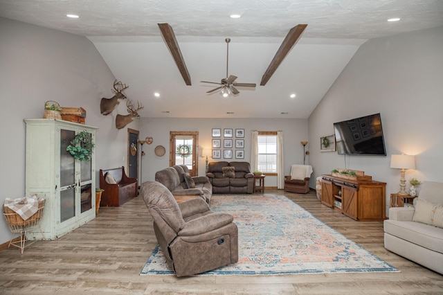 living area featuring lofted ceiling with beams, recessed lighting, a ceiling fan, and light wood-style floors