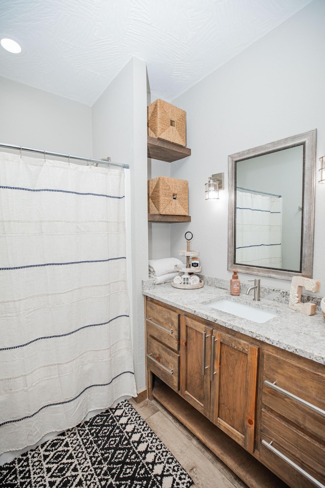 full bath featuring vanity and a shower with curtain