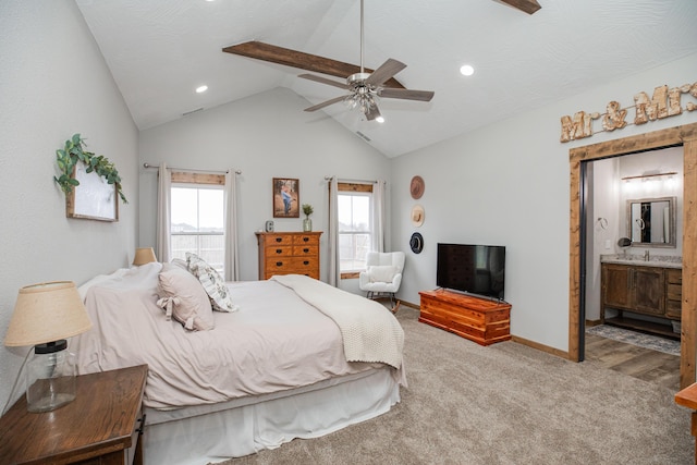 carpeted bedroom with lofted ceiling, ceiling fan, a textured ceiling, ensuite bathroom, and baseboards