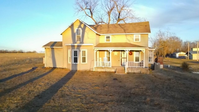 view of front facade with central air condition unit and a porch