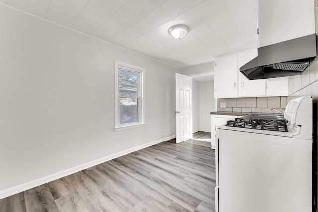 kitchen featuring light wood-style flooring, white cabinetry, and gas range gas stove