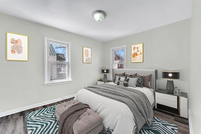 bedroom with baseboards and wood finished floors