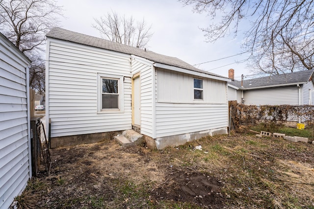 rear view of house with fence