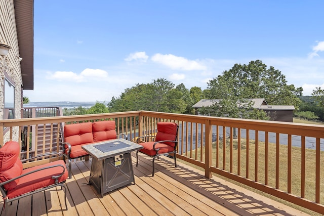 wooden terrace with an outdoor fire pit