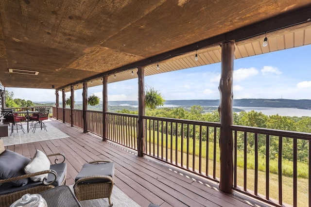 wooden deck featuring a water view