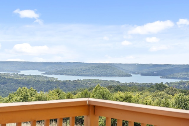 exterior space featuring a water view and a wooded view