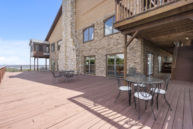 wooden terrace with outdoor dining area