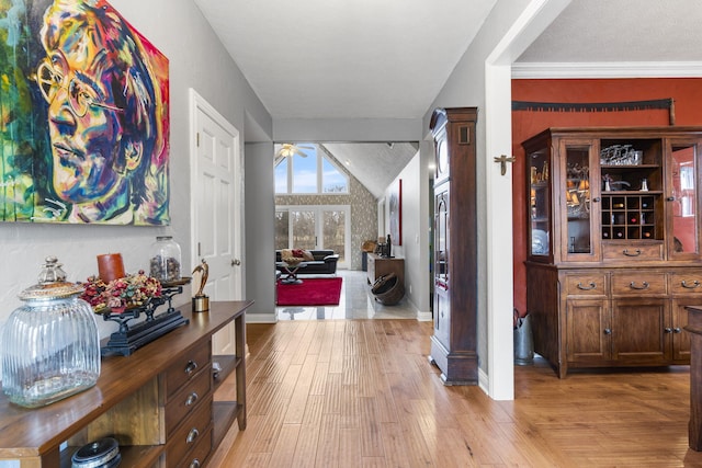 hallway featuring light wood-type flooring and baseboards